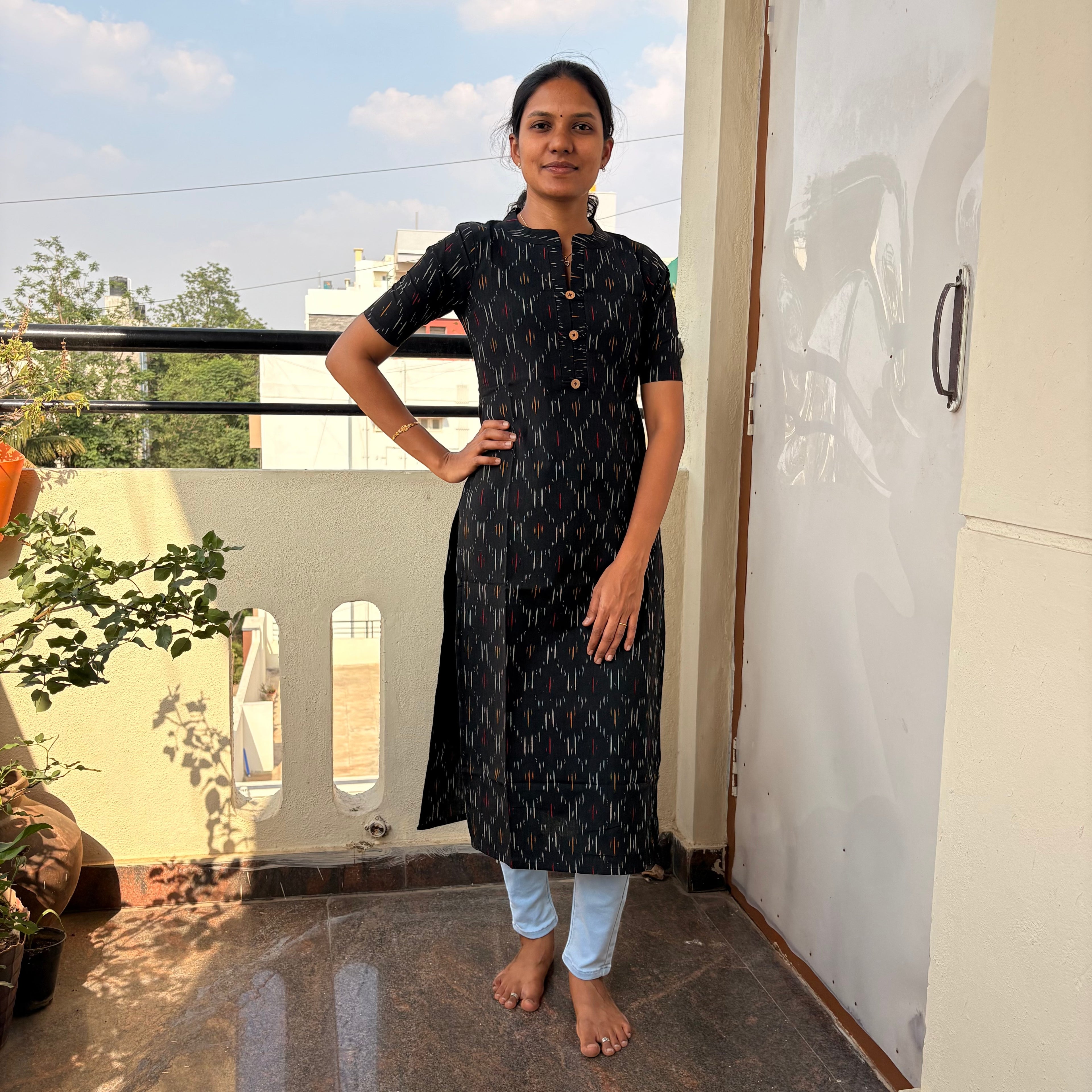 Houseofmagal black ikkat kurti with short sleeves and a mandarin collar. Features a vertical geometric pattern.